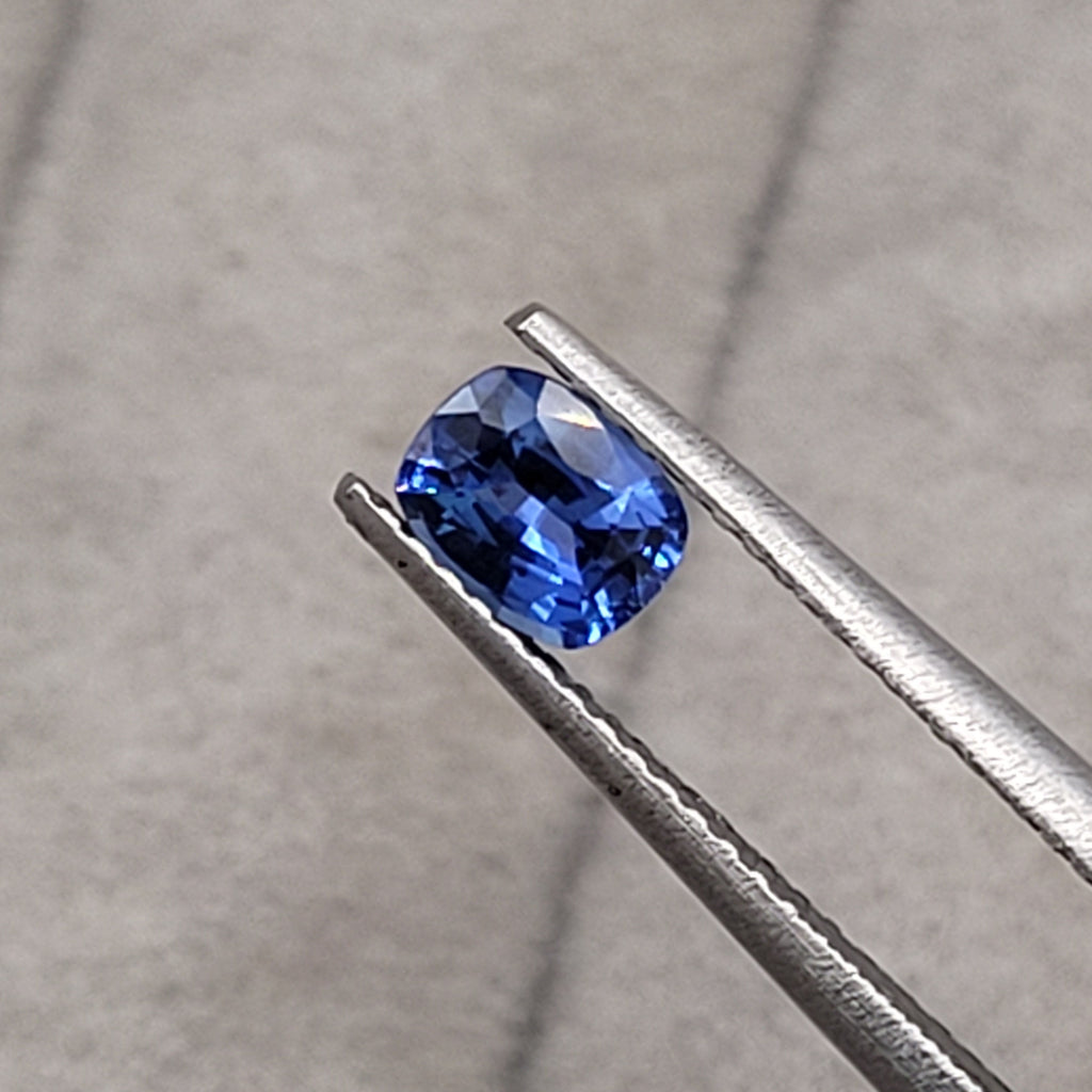 0.63 CT Natural Blue Sapphire - Unheated_cushion_heldby_tweezer